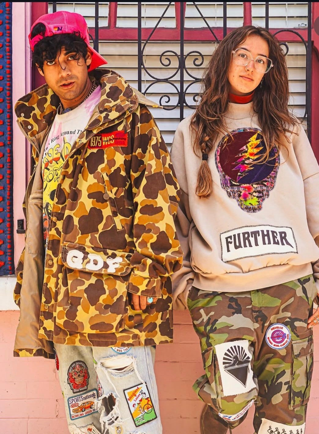 Couple in Further branded sweatshirts with camo print hoodie and Stealie crewneck with patched pants